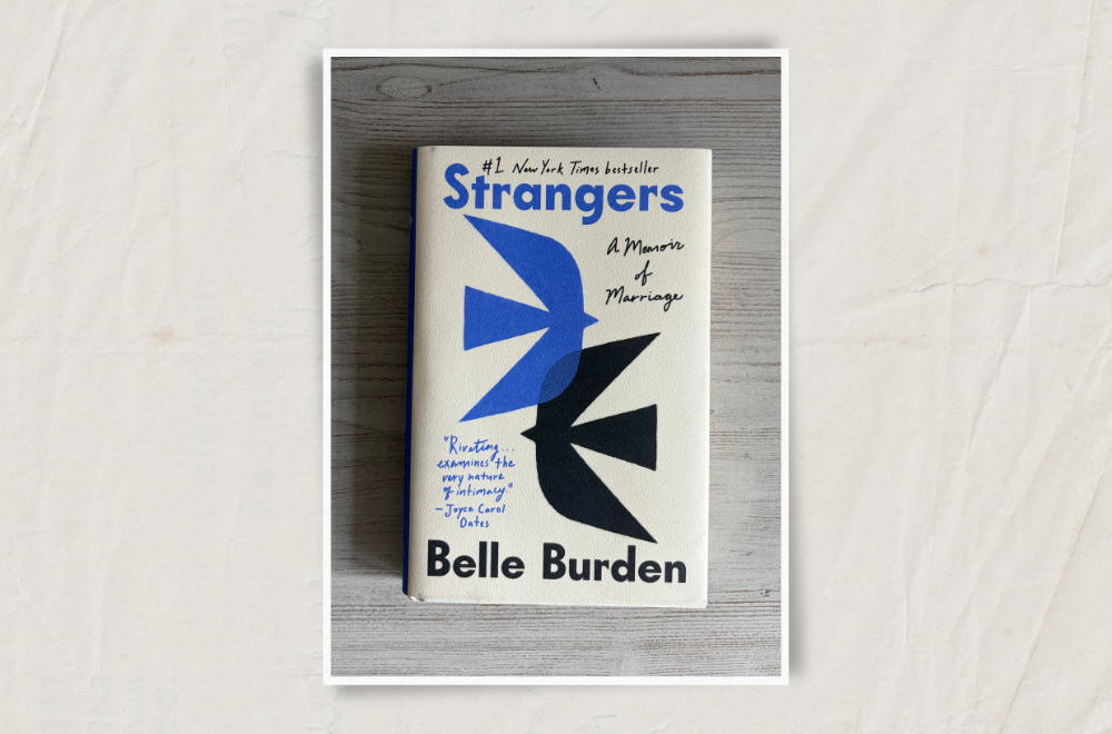 The cover for Strangers on a grey wood background